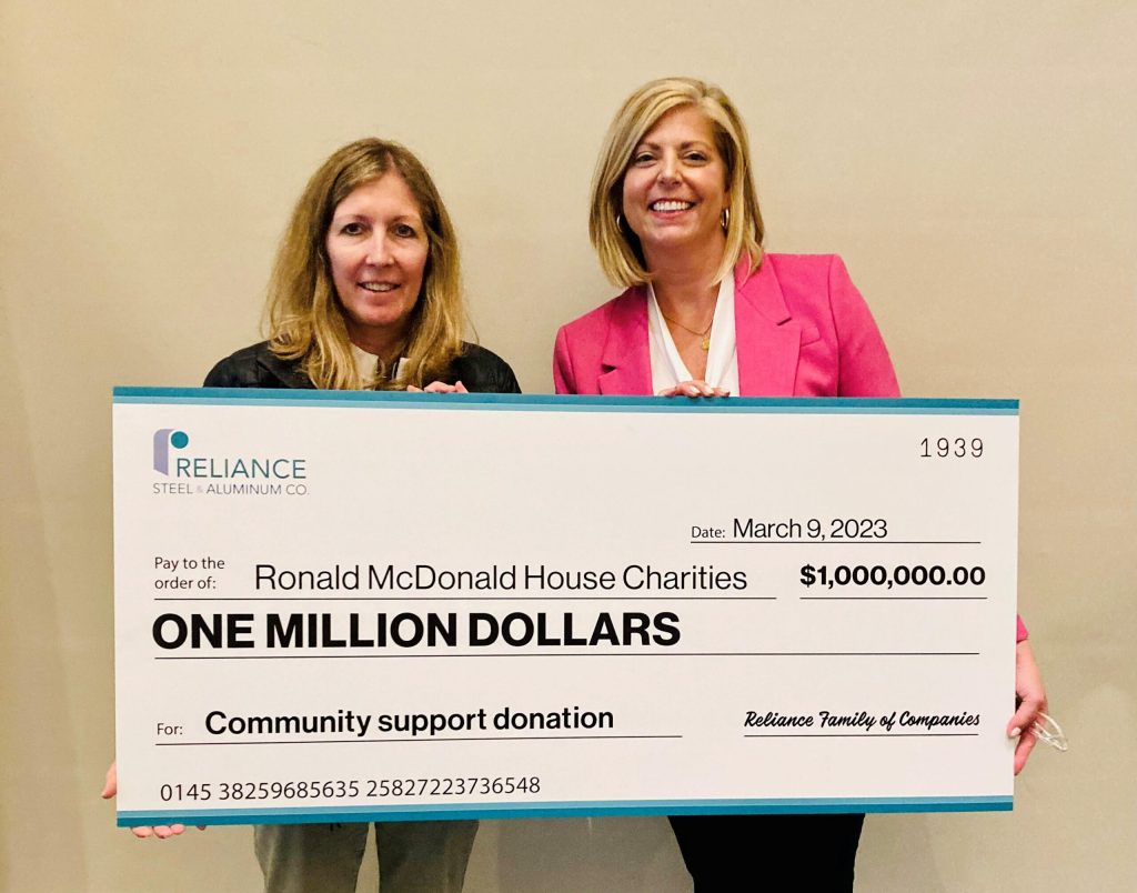Two women hold a Reliance Steel & Aluminum Co. ceremonial donation check for Ronald McDonald House Charities dated March 9, 2023, in the amount of one million dollars.