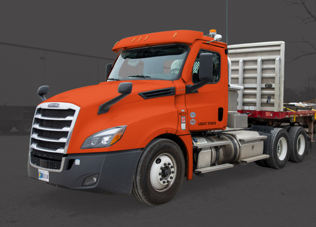 Orange flatbed semi-truck transporting bundled steel materials for metal delivery and logistics
